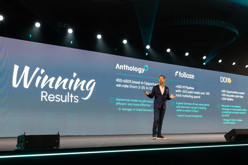 man on stage presenting