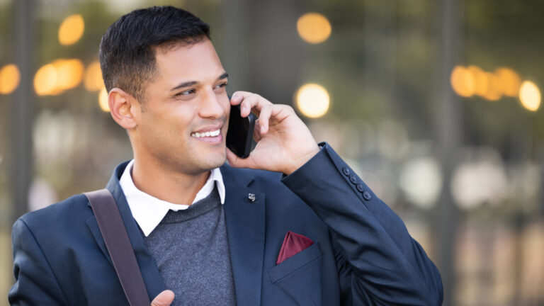 man in blue blazer on cell phone